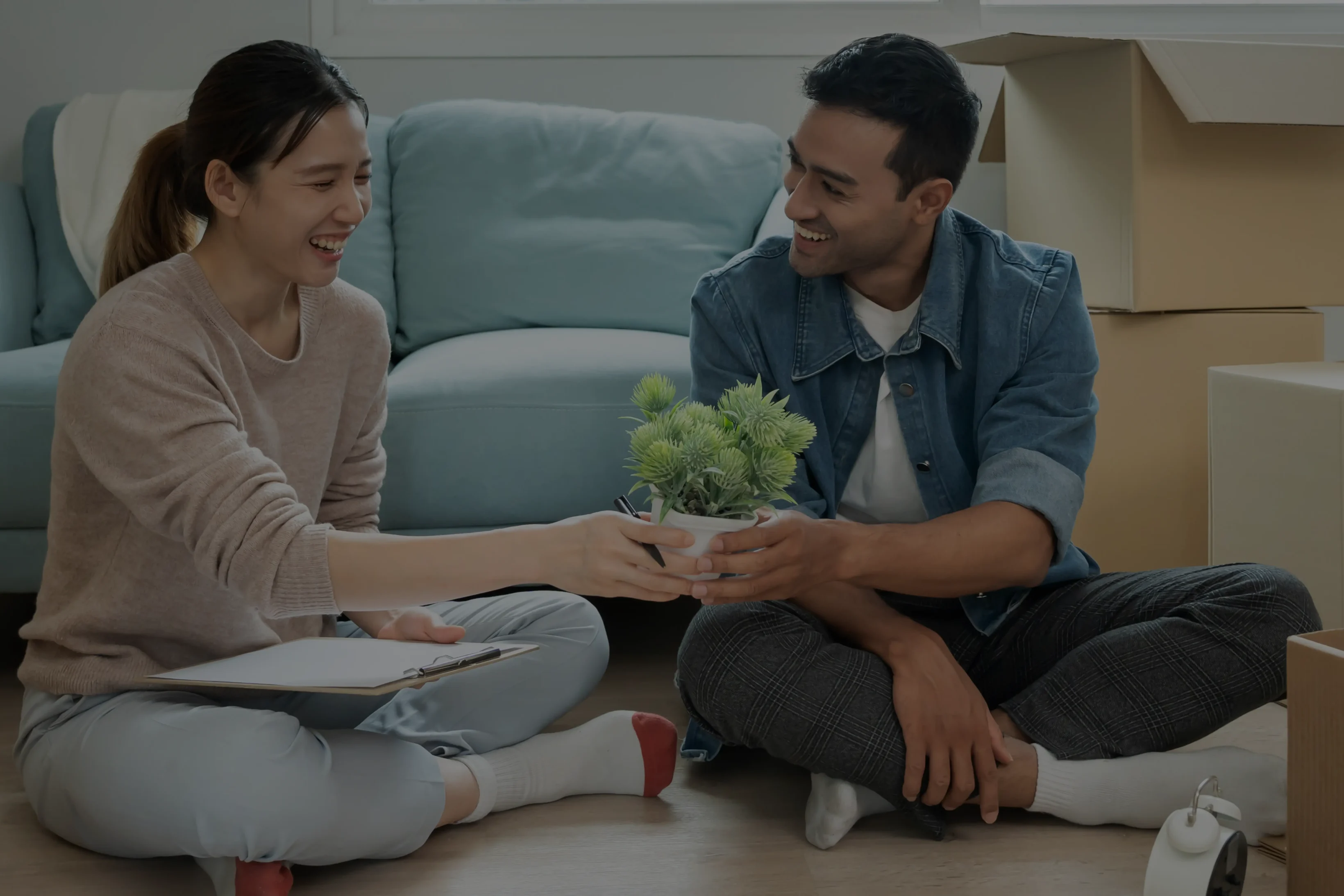 Moving house, relocation. Couple help set and move furniture for new apartment, inside the room was a cardboard box contain personal belongings. move in the new apartment or condominium